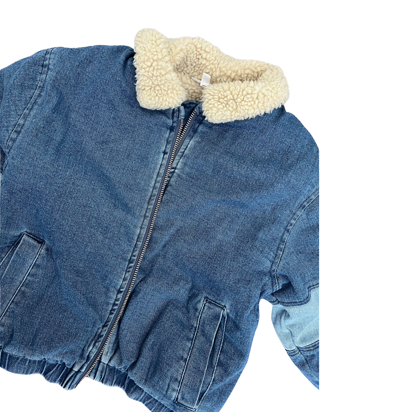 A cropped blue denim jacket with a cream-colored sherpa fleece collar, shown on a plain white background.